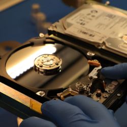 ProTek cleanroom hard drive recovery preparing platter cleaning after lid-rim dust contamination.