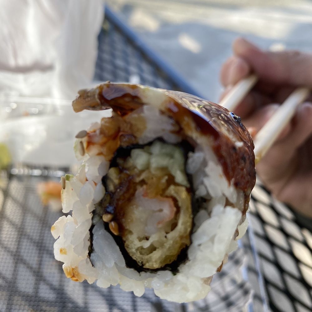 Yo Sushi - a hand holding a piece of sushi - Sushi Bars Near Me - Albany, California Yo Sushi - a hand holding a piece of sushi - Sushi Bars Near Me - Albany, California