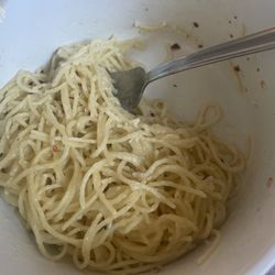 Caruso's Italian Restaurant & Pizzeria - It's leftovers from my visit I forgot to take a picture but it's angel hair pasta and Alfredo I added the pepper flakes