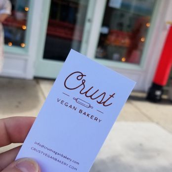 Crust Vegan Bakery - a hand holding a business card - Bakeries Near Me - Philadelphia, Pennsylvania Crust Vegan Bakery - a hand holding a business card - Bakeries Near Me - Philadelphia, Pennsylvania