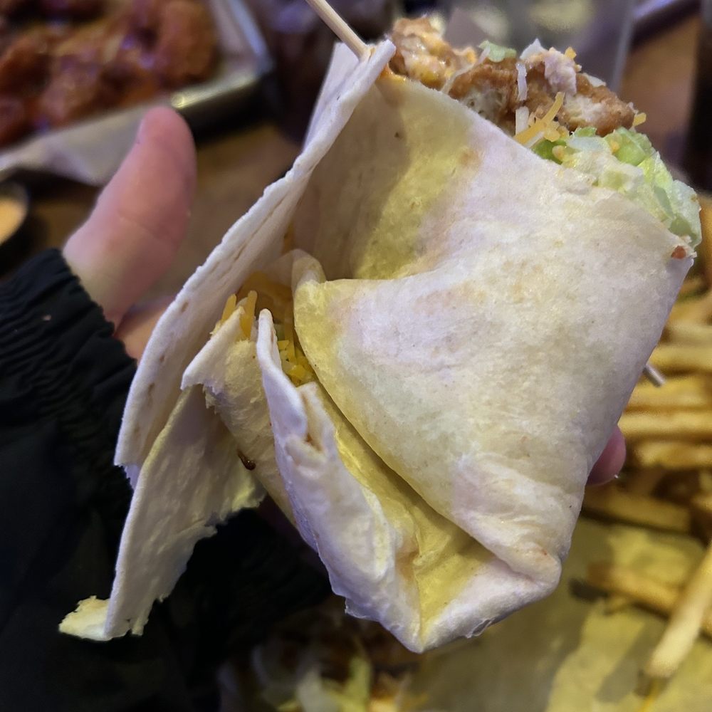 Buffalo Wild Wings - a hand holding a burrito - Chicken Wings Near Me - Battle Creek, Michigan Buffalo Wild Wings - a hand holding a burrito - Chicken Wings Near Me - Battle Creek, Michigan