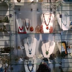 Silk Road Traveler - Interesting necklaces and earrings displayed with various stones.
