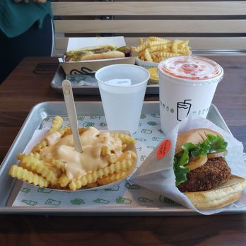 Shake Shack - 'Shroom Burger with Cheese Fries & Shack-cago Dog with Fries in the background. - Burgers Near Me - Long Beach, California Shake Shack - 'Shroom Burger with Cheese Fries & Shack-cago Dog with Fries in the background. - Burgers Near Me - Long Beach, California