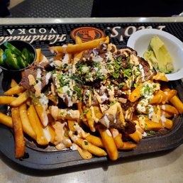 a plate of fries and a bowl of salsa