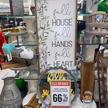Hobby Lobby - A vertical decorative sign with the quote 'full house, full hands, full heart' is displayed among various home decor items at a store, with a clearance sign indicating 66% off. - Hobby Shops Near Me - Laurel, Maryland