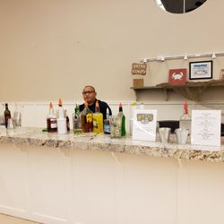 Drinks On Us Bartending - Fante finishing setting up bar at crab feed event for West Sierra High School.