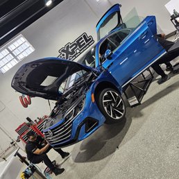 AB Wraps Miami installing XPEL Ultimate Fusion paint protection film all over the vehicle.