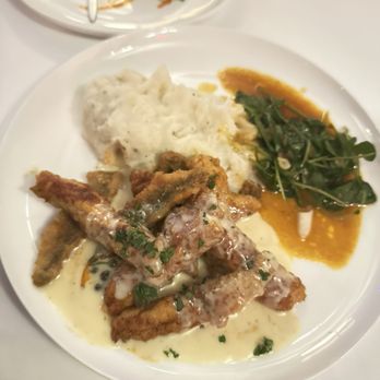 Caucus Club - Yellow Belly Michigan Lake Perch with sautéed garlic mashed potatoes, wilted watercress, lemon and caper beurre blanc - Steakhouses Near Me - Detroit, Michigan Caucus Club - Yellow Belly Michigan Lake Perch with sautéed garlic mashed potatoes, wilted watercress, lemon and caper beurre blanc - Steakhouses Near Me - Detroit, Michigan