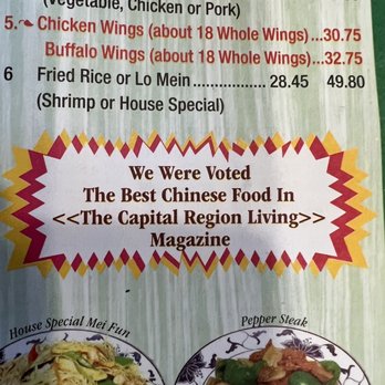 Mings - a menu for a chinese restaurant - The menu displays various Chinese food options, including chicken wings, fried rice, and lo mein, with prices listed next to each item. A highlighted section mentions the restaurant's award as the best Chinese food in the Capital Region Living Magazine. The lower part of the image shows partial photos of dishes like House Special Mei Fun and Pepper Steak, with colorful decorative borders around the award statement. - Chinese Near Me - Schenectady, New York