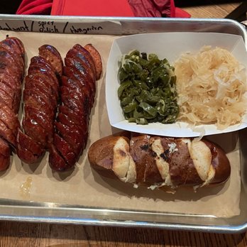 Wursthaus - 3 sausage platter with pretzel and two sides (kraut and sautéed jalapenos) - Pubs Near Me - Santa Ana, California Wursthaus - 3 sausage platter with pretzel and two sides (kraut and sautéed jalapenos) - Pubs Near Me - Santa Ana, California