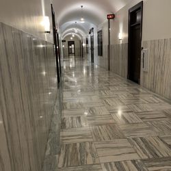 Drury Plaza Hotel Cleveland Downtown - Wide marble hallways with tall ceilings, vintage light fixtures and restored signs. It feels like you're going into a beautiful office.