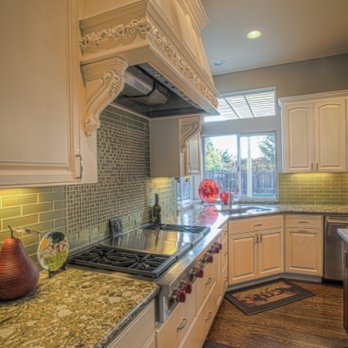 DoBel Construction - a kitchen with white cabinets and granite countertops - General Contractors Near Me - San Carlos, California