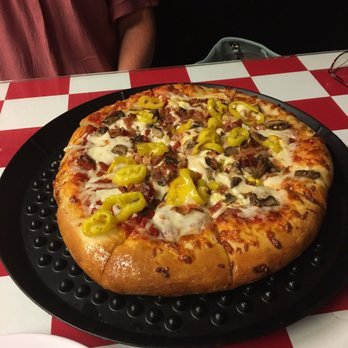 Greek's Pizzeria - a pizza on a black plate - Italian Near Me - Lebanon, Indiana Greek's Pizzeria - a pizza on a black plate - Italian Near Me - Lebanon, Indiana