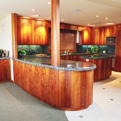 Mark Bucon Design Architect - Koa cabinets with 20' steel beam above