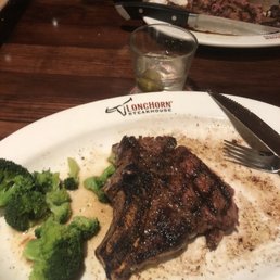 Outlaw Ribeye with a side of Fresh Steamed Broccoli being destroyed Outlaw Ribeye with a side of Fresh Steamed Broccoli being destroyed