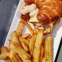 Smoked turkey and brie croissant with a side of fries Smoked turkey and brie croissant with a side of fries