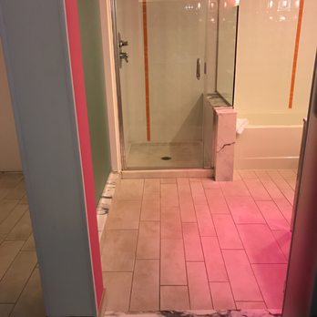 Flamingo Las Vegas - Bathroom. Ew.  Orange on the bathroom tile wall. Pink paint on the wall. Brown carpet. And the marble. - Hotels Near Me - Las Vegas, Nevada
