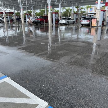Wawa - a wet parking lot with a gas station in the background - Gas Stations Near Me - Ft Lauderdale, Florida Wawa - a wet parking lot with a gas station in the background - Gas Stations Near Me - Ft Lauderdale, Florida