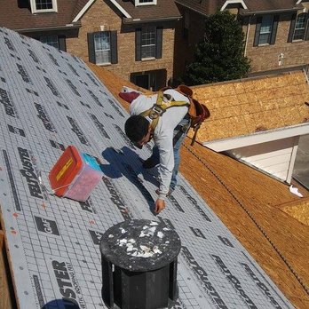 Trademark Roofing & Construction - a man working on a roof - Roofing Near Me - Conroe, Texas
