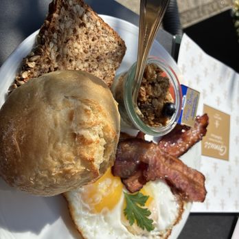 Kaffeehaus Dichtl - Eggs, bacon, German roll and bread and yoghurt topped with Müsli. - Cafes Near Me - Augsburg, BY