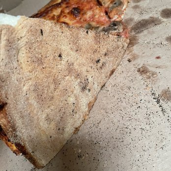 NYPD Pizza - More black burnt toast crumbs under the pie - Pizza Near Me - Chandler, Arizona NYPD Pizza - More black burnt toast crumbs under the pie - Pizza Near Me - Chandler, Arizona