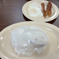 Curleys Cafe - Biscuits and gravy with over medium eggs and bacon.