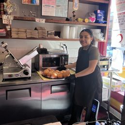 Nina, the daughter's owner assembling the freshly made Arancini. Amazing Italian rice balls with meat sauce Nina, the daughter's owner assembling the freshly made Arancini. Amazing Italian rice balls with meat sauce