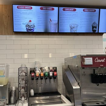 Cinnabon - a coffee shop with a menu on the wall - Bakeries Near Me - Brooklyn, New York