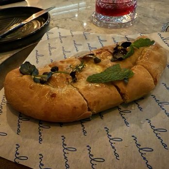 Melina - Cheese pie filled with feta cheese, topped with spicy pepper honey and basil. - Greek Near Me - North Bethesda, Maryland