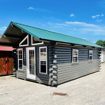 Beyond The Backyard - a small log cabin with a green roof - Sheds & Outdoor Storage Near Me - Waco, Texas