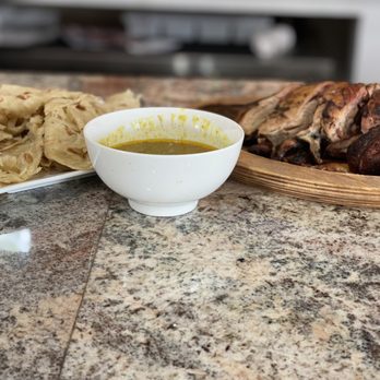 TriniJam BK - a bowl of soup and a plate of food - Trinidadian Near Me - Brooklyn, New York