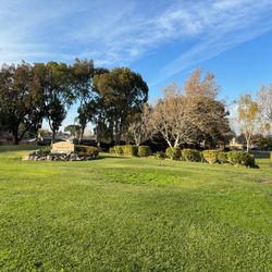 Hillsdale Park - Large grassy area between street sidewalk and signage