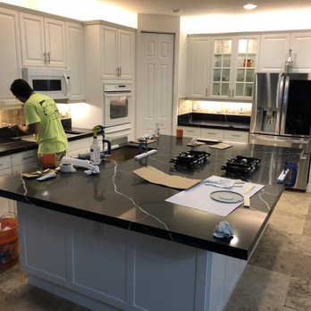 Stone Design Source - a woman in a kitchen - Flooring Near Me - Miami, Florida Stone Design Source - a woman in a kitchen - Flooring Near Me - Miami, Florida