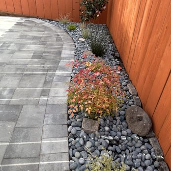 Tin Landscaping - Beautiful rock garden along power washed and stained fence - Landscaping Near Me Tin Landscaping - Beautiful rock garden along power washed and stained fence - Landscaping Near Me