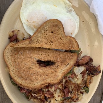 Snooze, an A.M. Eatery - Corned beef hash with over easy eggs and wheat toasts. - Breakfast & Brunch Near Me - Orange, California Snooze, an A.M. Eatery - Corned beef hash with over easy eggs and wheat toasts. - Breakfast & Brunch Near Me - Orange, California