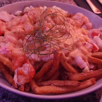 Buvette Thérèse - a bowl of french fries and crab salad - Wine Bars Near Me - Percé, Quebec