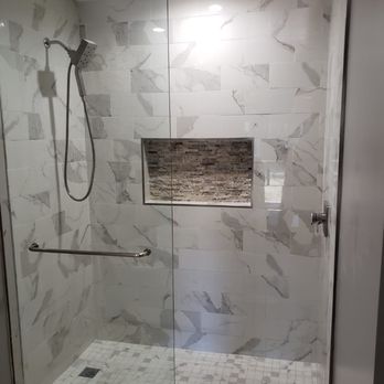 Grid Builders - a shower with a glass door - General Contractors Near Me
