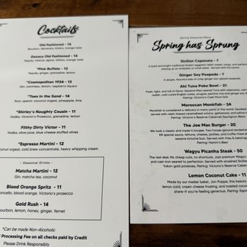 Kitchen and Rail - menu - Two printed menus are displayed on a wooden table, one listing cocktails and the other featuring spring seasonal dishes, with a focus on beverages and food options. - Bars Near Me - Eagan, Minnesota