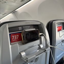 American Airlines - Notice place for phone, charging port, and the QR code up top to get the free in-flight entertainment.