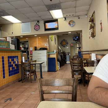 Ernesto's Taco Shop - a man sitting at a table - Mexican Near Me - Miami, Florida Ernesto's Taco Shop - a man sitting at a table - Mexican Near Me - Miami, Florida