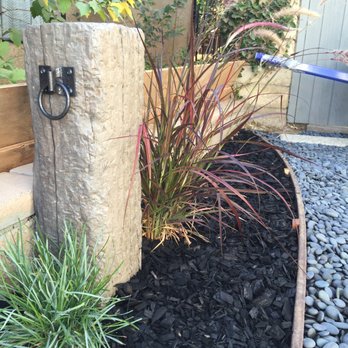 Tri-County Turf - Detail of decorative old post and grasses - Landscaping Near Me