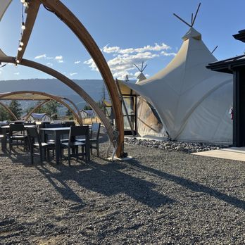 Under Canvas Columbia River Gorge - Outdoor tables and three large fire pits just outside the lobby tent building and cafe. - Resorts Near Me - White Salmon, Washington