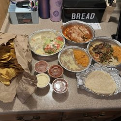 Los Tres Agaves 2 - Bottom/fajita with veggies-side of rice and beans Top/steak chimichangas w salad  Left side/chips w queso and salsa dip