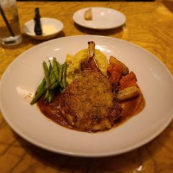 Grand Lux Cafe - Parmesan crusted porkchop with mashed potatoes, green beans and sauteed carrots and parsnips