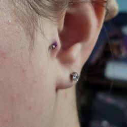 HardRocs Tattoo - Right ear.  Why is it so close to her head? It looks worse in person, hard to capture in the picture.