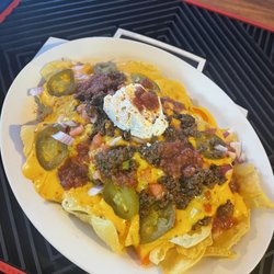Nachos! Seasoned beef or chicken with jalapeños, tomato, onion and melted cheese topped with sour cream and salsa!