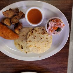 Pupuseria La Paz - Pupusas, empanada, and chicharron with condiments.