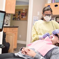 Dr. R Kaur Family Dentistry - Dr. R Kaur Treating Patient