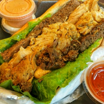 Zunzi's - THE GODFATHER: baked chicken & South African sausage with lettuce & tomato on French bread, with sauces on the side - Sandwiches Near Me - Savannah, Georgia Zunzi's - THE GODFATHER: baked chicken & South African sausage with lettuce & tomato on French bread, with sauces on the side - Sandwiches Near Me - Savannah, Georgia