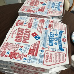 a stack of pizza boxes on a table